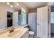 This bathroom features a single vanity, toilet, window, and tub/shower combo at 5260 Morning Glory Pl, Highlands Ranch, CO 80130