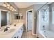 Bathroom with double vanity, tub/shower combo, and neutral color palette at 5260 Morning Glory Pl, Highlands Ranch, CO 80130