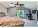 This bedroom features an attached desk, a ceiling fan, and a lovely window at 5260 Morning Glory Pl, Highlands Ranch, CO 80130