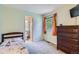 This bedroom features a twin bed, a dresser, a window, and neutral walls at 5260 Morning Glory Pl, Highlands Ranch, CO 80130