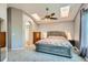 Spacious bedroom boasts skylights, ceiling fan, and ensuite bathroom access at 5260 Morning Glory Pl, Highlands Ranch, CO 80130