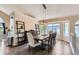Bright dining area featuring an elegant chandelier, a large window, and ample space for entertaining at 5260 Morning Glory Pl, Highlands Ranch, CO 80130
