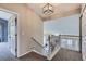 Hallway with carpet, stairs and a modern light fixture at 5260 Morning Glory Pl, Highlands Ranch, CO 80130