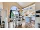 Bright kitchen features stainless steel appliances, island, and dining table by large window at 5260 Morning Glory Pl, Highlands Ranch, CO 80130