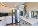Modern kitchen featuring stainless steel appliances, granite countertops, white cabinetry, and hardwood flooring at 5260 Morning Glory Pl, Highlands Ranch, CO 80130