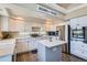 Beautiful kitchen with a functional island, modern appliances, crisp white cabinetry, and hardwood floors at 5260 Morning Glory Pl, Highlands Ranch, CO 80130