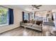 Spacious living room showcases dark hardwood floors, generous natural light, and seamless integration with the kitchen area at 5260 Morning Glory Pl, Highlands Ranch, CO 80130