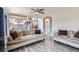 Open-concept living area with hardwood floors and access to the adjacent kitchen and dining areas at 5260 Morning Glory Pl, Highlands Ranch, CO 80130