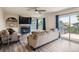 Cozy living room with a fireplace, a ceiling fan, a sliding door to the patio, and built-in shelving at 5260 Morning Glory Pl, Highlands Ranch, CO 80130