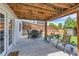 Back patio with outdoor dining and seating area with a view of the fenced backyard at 5260 Morning Glory Pl, Highlands Ranch, CO 80130