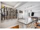 Finished basement bar with wine storage, barstools, and sink at 9673 Pinebrook St, Highlands Ranch, CO 80130