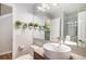 Stylish half-bathroom featuring modern lighting, a sleek sink, and decorative hanging plants at 9673 Pinebrook St, Highlands Ranch, CO 80130