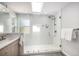 Bright bathroom featuring white tile and glass enclosed shower, providing a clean and modern look at 9673 Pinebrook St, Highlands Ranch, CO 80130