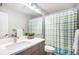 Bathroom featuring vanity, mirror, and tub/shower combo with a colorful curtain at 9673 Pinebrook St, Highlands Ranch, CO 80130