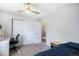 Bedroom with a large closet, carpet, desk, ceiling fan and view to stairs at 9673 Pinebrook St, Highlands Ranch, CO 80130