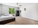 Inviting bedroom with carpet, a large window, and a ceiling fan creating a relaxing atmosphere at 9673 Pinebrook St, Highlands Ranch, CO 80130