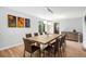 Bright dining room with a modern table set, wood floors, and three unique pieces of modern art at 9673 Pinebrook St, Highlands Ranch, CO 80130