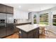 Modern kitchen featuring an island, breakfast nook, and stainless steel appliances with backyard view at 9673 Pinebrook St, Highlands Ranch, CO 80130