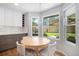 Breakfast nook with table and seating, offering a view of the backyard and access to modern kitchen amenities at 9673 Pinebrook St, Highlands Ranch, CO 80130