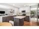 Well-lit kitchen with an island, hardwood floors, and granite countertops, offering a blend of style and functionality at 9673 Pinebrook St, Highlands Ranch, CO 80130