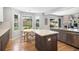 Modern kitchen featuring an island, breakfast nook, and stainless steel appliances overlooking a fenced backyard at 9673 Pinebrook St, Highlands Ranch, CO 80130