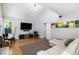 Bright living room features a vaulted ceiling, hardwood floors, and a large sectional sofa at 9673 Pinebrook St, Highlands Ranch, CO 80130