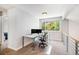 Bright office space featuring modern desk, dual monitors, and a large window at 9673 Pinebrook St, Highlands Ranch, CO 80130