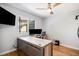 Home office with wood floors, a large window, and a modern desk with dual monitors at 9673 Pinebrook St, Highlands Ranch, CO 80130