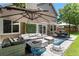 Inviting patio area with comfortable seating, a fire pit, and an outdoor dining set at 9673 Pinebrook St, Highlands Ranch, CO 80130