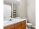 Modern bathroom with a vanity, sink, and a large mirror with a view to the shower at 9692 W Coco Cir # 103, Littleton, CO 80128
