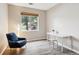 Well-lit bedroom featuring a desk, chair, and a large window at 9692 W Coco Cir # 103, Littleton, CO 80128