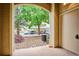 View from the doorway showcasing a landscaped parking area with mature trees and assigned parking spaces at 9692 W Coco Cir # 103, Littleton, CO 80128