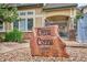 Close-up of the Deer Creek Clubhouse sign with manicured landscaping in a peaceful neighborhood at 9692 W Coco Cir # 103, Littleton, CO 80128