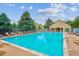 Outdoor community pool with lounge chairs, clear water, and nearby clubhouse on a sunny day at 9692 W Coco Cir # 103, Littleton, CO 80128