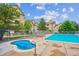 Outdoor community pool and hot tub with lounge chairs and well-maintained buildings in the background at 9692 W Coco Cir # 103, Littleton, CO 80128
