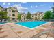 Outdoor community pool with lounge chairs and well-maintained residential buildings in the background at 9692 W Coco Cir # 103, Littleton, CO 80128