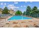 Outdoor community pool with lounge chairs, clear water, and nearby residential buildings on a sunny day at 9692 W Coco Cir # 103, Littleton, CO 80128