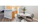 Dining area next to a kitchen with wood cabinets at 9692 W Coco Cir # 103, Littleton, CO 80128