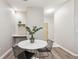 Inviting dining area with modern table and chairs near the kitchen at 9692 W Coco Cir # 103, Littleton, CO 80128