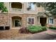 Aesthetic exterior stone detail and manicured landscaping at 9692 W Coco Cir # 103, Littleton, CO 80128