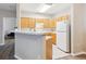 Well-equipped kitchen featuring wood cabinets and modern white appliances at 9692 W Coco Cir # 103, Littleton, CO 80128