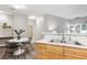 Kitchen area with wood cabinets, breakfast bar, and view of the dining space at 9692 W Coco Cir # 103, Littleton, CO 80128