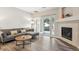 Inviting living room with fireplace, wood floors, and sliding glass doors at 9692 W Coco Cir # 103, Littleton, CO 80128
