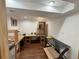 Basement with wooden floors being used as a workshop with shelves and lighting at 971 S Evanston Cir, Aurora, CO 80012