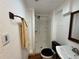 Compact bathroom featuring a toilet, sink, and shower with white fixtures at 971 S Evanston Cir, Aurora, CO 80012