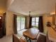 The dining area features a wood table and seating, and is adjacent to the kitchen and large sliding glass door at 971 S Evanston Cir, Aurora, CO 80012
