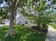 Well-maintained home exterior with lush green lawn and mature trees at 971 S Evanston Cir, Aurora, CO 80012