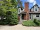 Charming home featuring a brick chimney, dormer windows, and lush landscaping for added curb appeal at 971 S Evanston Cir, Aurora, CO 80012