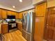 Bright kitchen featuring stainless steel appliances, wood cabinets, and modern countertops at 971 S Evanston Cir, Aurora, CO 80012