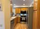 Functional kitchen featuring stainless steel appliances, wood cabinets, and modern countertops at 971 S Evanston Cir, Aurora, CO 80012